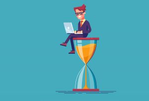 Businessman sitting on the hourglass with laptop legs crossed